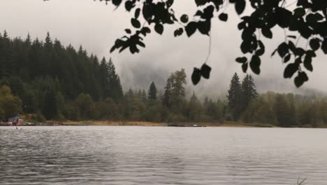 Foggy-scenery-view-of-tranquil-Alta-Lake-with-gentle-water-ripples-on-the-surface-with-windy-and-rainy-weather,-Whistler-BC