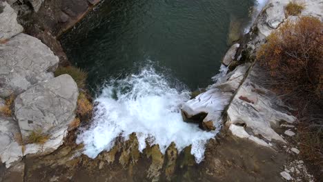 Aerial-top-down-view-over-Lundbreck-falls-in-slow-motion-slowly-ascending