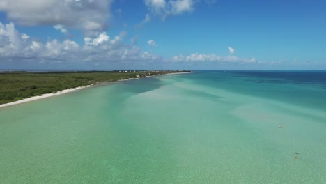 Aerial-shot-with-the-coast-on-one-side-and-the-turquoise-ocean-on-the-other-side