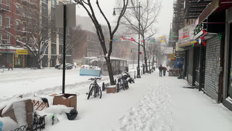 Dos-Hombres-Caminan-En-La-Acera-De-La-Ciudad-De-Nueva-York-En-La-Dura-Nieve-De-La-Bobinadora
