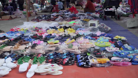 close-up-of-rubber-flip-flop-stand-in-outdoor-market,-Vietnam