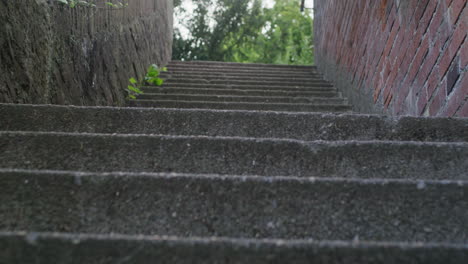 Gimbal-tracking-shot-of-walking-up-some-stone-stairs-in-Ulm
