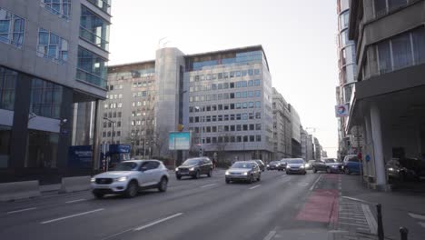 Wide-skyline-view-of-busy-road-Rue-Belliard-in-the-European-Quarter-in-Brussels,-Belgium-during-rush-hour