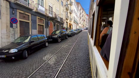 Vintage-tram-tour-in-Lisbon---tourist's-POV-from-the-opened-window-on-a-city-street-on-the-move-daytime