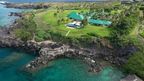 Aerial-view-of-a-large-expensive-house-on-the-rugged-coastline-in-Maui-Hawaii