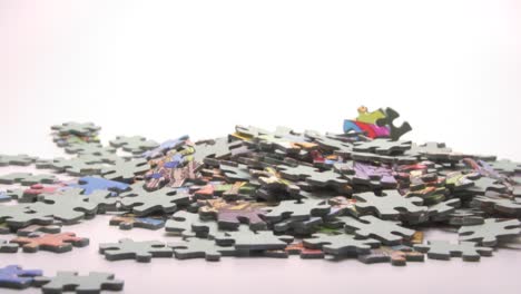 Jigsaw-Puzzle-Pieces-Falling-Against-White-Background