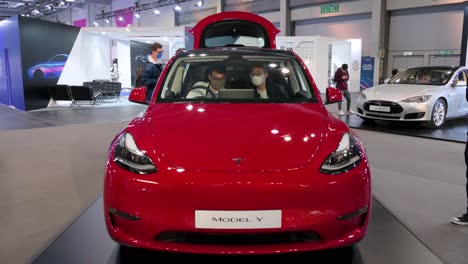 Visitors-sit-and-test-an-American-EV-electric-company-car-Tesla-Motors-car,-Tesla-Model-Y,-during-the-International-Motor-Expo-in-Hong-Kong