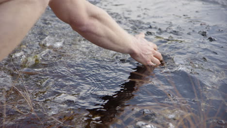 SLOW-MOTION---ice-bathers-hands-scooping-ice-away-to-clear-the-water