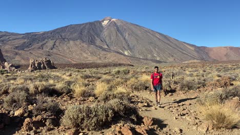 Sporty-young-boy-in-red-T-shirt-hiking-Teide-National-Park,-Tenerife