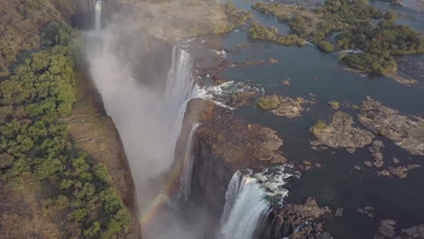 Aerial:-Dramatic-rainbow-forms-at-Victoria-Falls-on-Zambezi-River