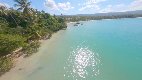 FPV-drone-shot-along-tropical-Playa-Bonita-beach-in-Las-Terrenas,-Caribbean