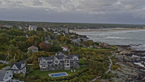 Ogunquit-Maine-Aerial-v4-low-level-drone-flyover-rocky-shore-capturing-townscape-with-shingle-style-architecture-design-coastal-homes-towards-main-beach---Shot-with-Inspire-2,-X7-camera---October-2021