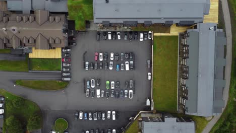 Hotel-lodging-and-resort-at-Vestlia-Geilo-seen-from-a-different-perspective---Cool-top-down-aerial-view-of-a-full-parking-lot-and-rooftop-architecture---Norway