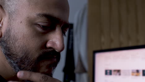 A-close-up-shot-of-an-anxious-Indian-man-subconsciously-stroking-his-facial-hair-while-deep-in-thought-on-trying-to-resolve-a-business-issue-in-his-mind