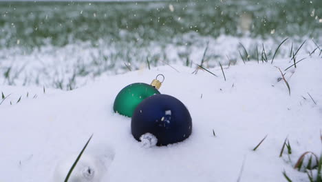 Dropping-down-Christmas-tree-toys-into-pile-of-pure-white-snow-during-snowfall