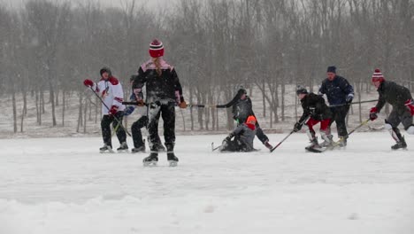 Wide-shot-of-a-large-group-of-adults-and-children-playing-pond-hockey