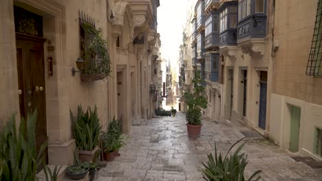 Walking-Down-on-Cobblestone-Stairs-in-Old-Town-of-Valletta-on-Sunny-Day