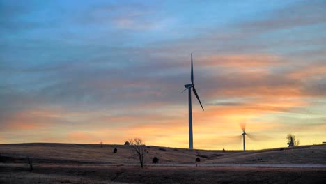 Time-lapse-wind-turbines-against-a-background-of-burning-sky