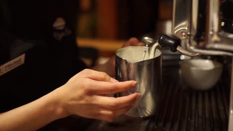 SLOWMO---Female-barista-frothing-milk-for-cappuccino---flat-white---latte---CLOSE-UP