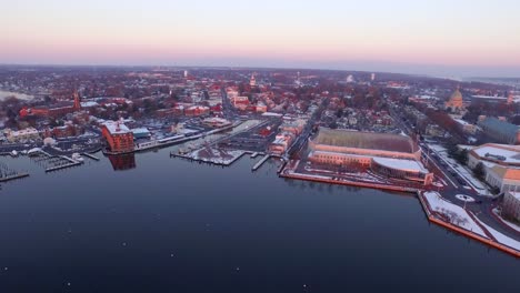 Ultra-wide-aerial-shot-of-purple-Annapolis-Harbor-at-dawn-with-boat-moorings-in-the-water