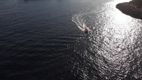 AERIAL:-flying-above-fast-motor-boat-on-the-sea-at-coast-of-Mallorca