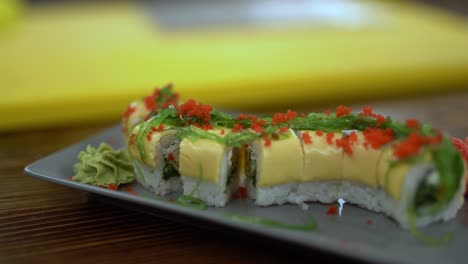 A-close-up-video-of-extremely-beautiful-and-tasty-sushi-roll-with-seaweed-and-caviar-on-it