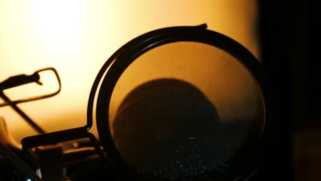 Zoom-out-right-panning-shot-of-back-lit-studio-microphone-silhouette