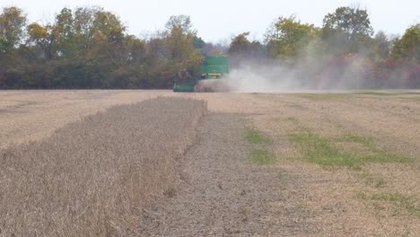 Back-side-of-a-John-Deere-9600-Combine-harvesting-soybean,-driving-away