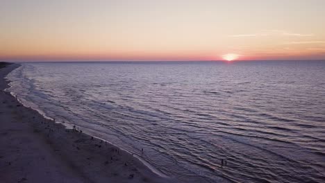 Drone-footage-of-a-sunset-over-Baltic-Sea,-Lubiatowo-Beach,-Poland
