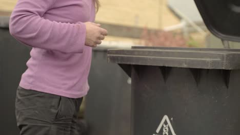 Woman-opening-the-garbage-bin-lid
