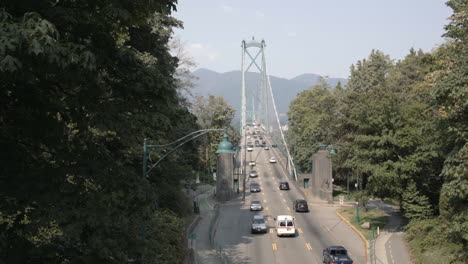 Wide-shot-of-cars-driving-through-Lions-Gate-bridge-in-Vancouver-on-sunny-day