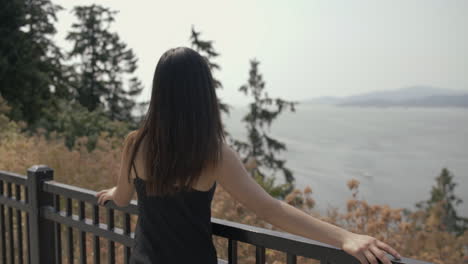 Young-Asian-girl-in-great-mood-enjoying-view-at-Prospect-point-and-looks-to-the-camera,-Slowmo