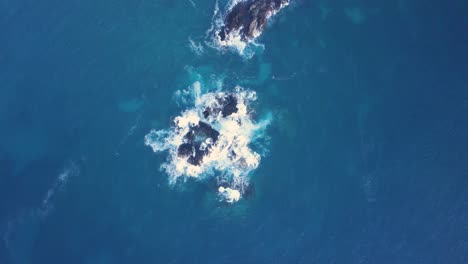 Aerial-tracking-shot-of-deep-blue-ocean-with-dark-cliffs-in-the-Philippines