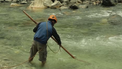 A-mountaineering-institute-trainee-crossing-a-mountainous-river-with-Single-wading-technique