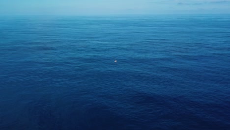 Drone-Shot-closing-in-on-a-boat-stranded-in-the-middle-of-the-deep-blue-sea
