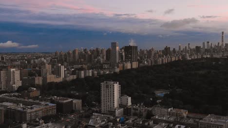 Drone-side-pullback-of-Harlem-NYC-facing-the-Upper-East-Side-at-sunset-in-4K