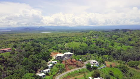 Drone-shot-of-nature-view-on-forest-and-vacation-destination-with-mountain-and-cloudy-sky-background-view,-Boca-Chica,-Panama