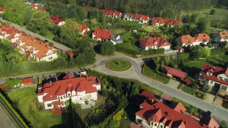 Aerial-view-of-a-new-housing-estate-in-the-suburbs,-camera-moving-left