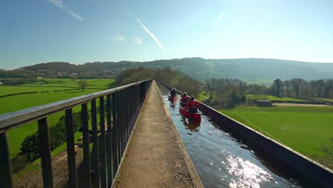 A-Kayak,-canoe-instructor-takes-his-clients-over-the-famous-Pontcysyllte-Aqueduct-on-the-Llangollen-canal-situated-in-North-Wales,-outdoors-extreme-sports