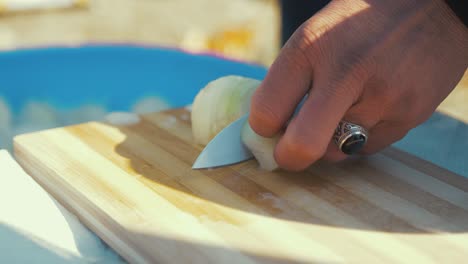 Tight-Shot-of-a-Refugee-Cutting-Onions-at-a-Refugee-Camp-in-Greece