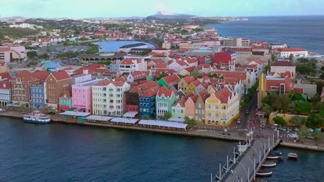 Colorful-historic-building-of-downtown-Willemstad-in-Curacao,-panning-aerial-shot-of-waterfront