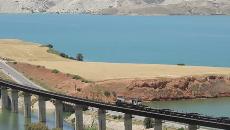 Diesel-Cargo-train-crossing-a-bridge-beside-the-IDRISS-FIRST-dam