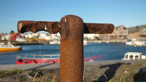 Static-shot,-of-a-rusty,-old-cleat-point,-boat-dock,-at-a-pier,-on-a-sunny-and-windy-day,-in-Lista,-Norway