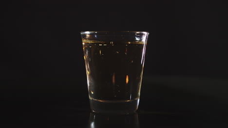 Silhouette-of-a-Shot-Glass-being-filled-with-Whiskey