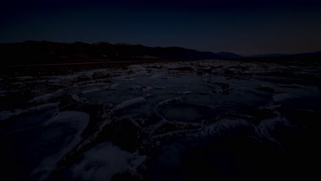 Pull-back,-panning-time-lapse-of-salt-crystal-formations-and-salt-water-pools-at-dusk