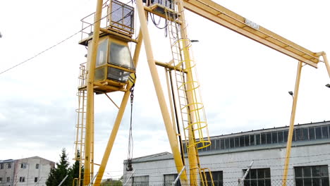 Yellow-gantry-crane-in-a-suburban-factory
