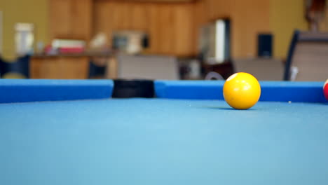 Number-one-pool-ball-rolling-around-on-billiards-table
