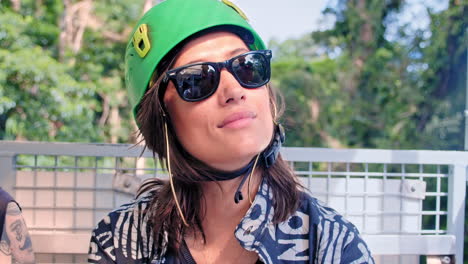 Close-Up-of-Beautiful-Brunette-Girl-With-Helmet-and-Sunglasses-Looking-Confidently-at-the-Sun-Ready-for-Zip-Lining-Activity