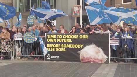 Slow-motion-close-up-of-Scottish-protesters-and-their-flags-outside-the-Perth-Concert-Hall-where-the-Tory-Leadership-Hustings-is-being-held