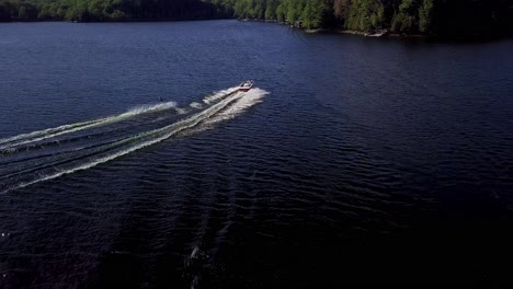 Girl-Water-Skiing,-Wide-Aerial-Drone-Tracking-View